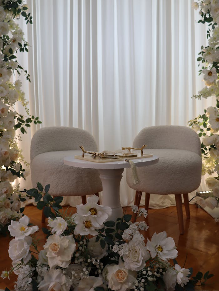 Beautiful wedding setup with elegant chairs and floral arrangements, perfect for romantic events.